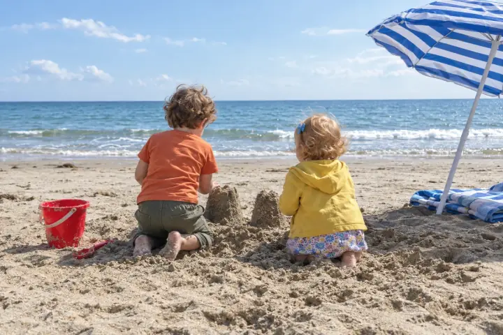 A made-up family photo of Pip and Wren at the beach